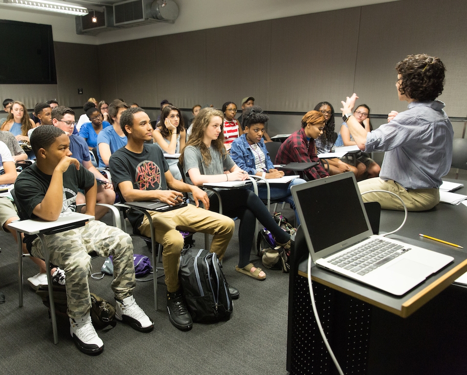 Students listening to a professor in a classroom